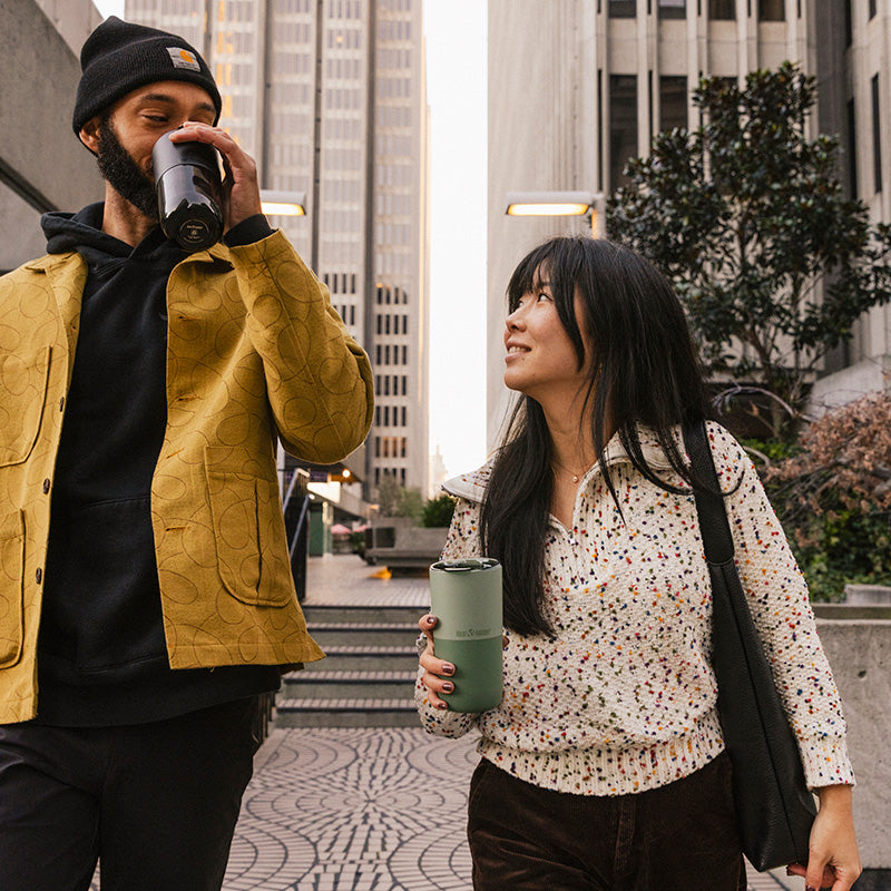 16oz-rise-tumbler-b7 16oz_rise_tumbler_black_iceberg_couple_drink_city_street_square.jpg