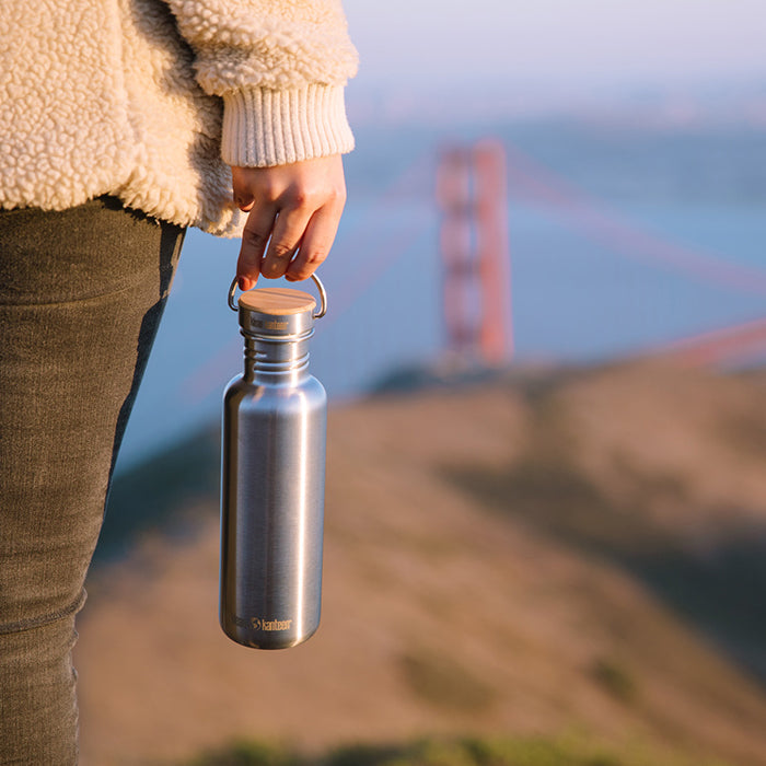 27oz-reflect-with-bamboo-cap-k6 K27SSLRF-BS-BAMBOO_reflect_bottle_bridge_lifestyle.jpg